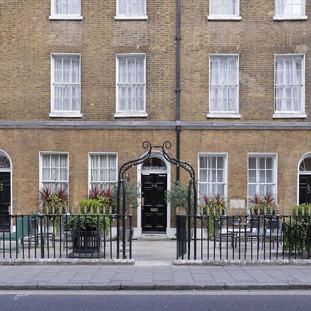 Montcalm Brewery Townhouse Hotel London Exterior photo The photo shows a row of three-story brick buildings, featuring a classic design with large windows and decorative ironwork. The buildings are painted in a muted yellow-brown color, typical of older urban architecture. In front of the buildings, ther